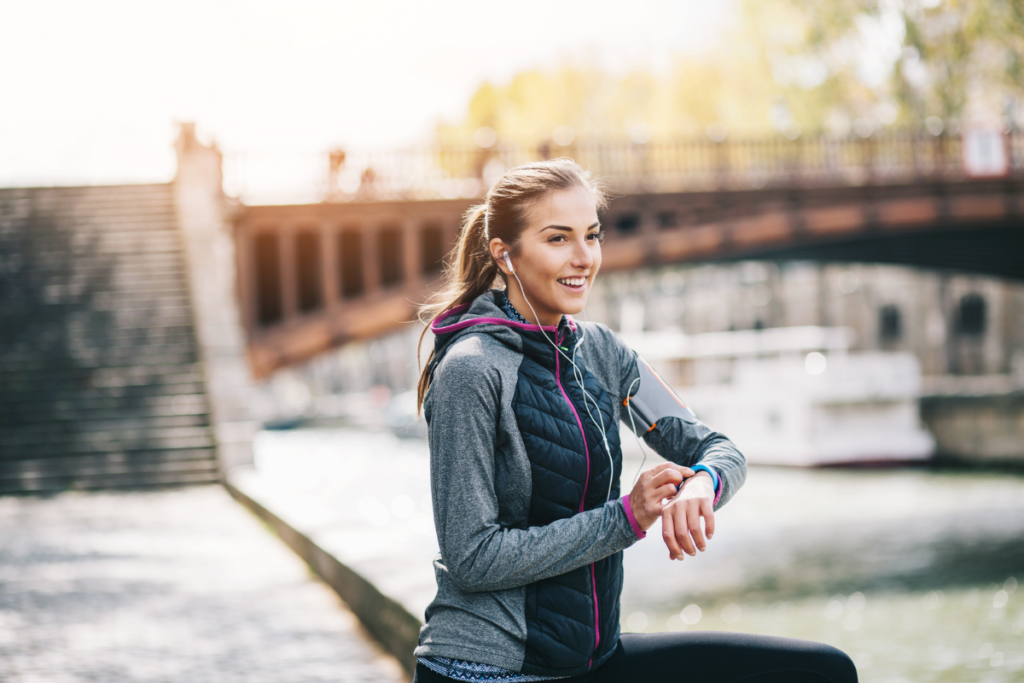 Runner looking at wearable health tracker