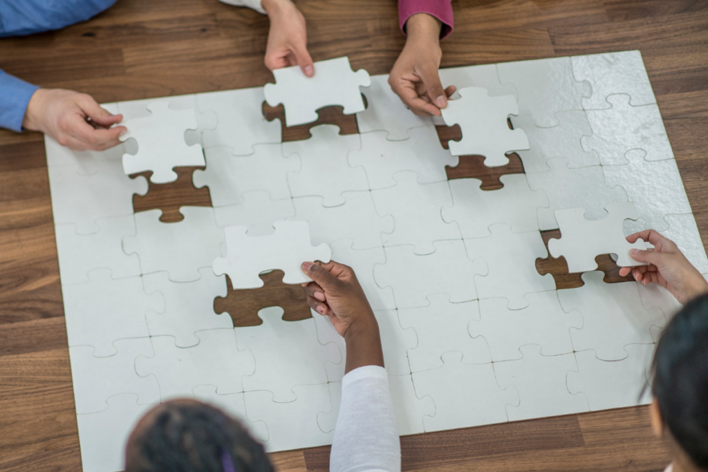 HealthTech team showing problem solving skills by completing a puzzle